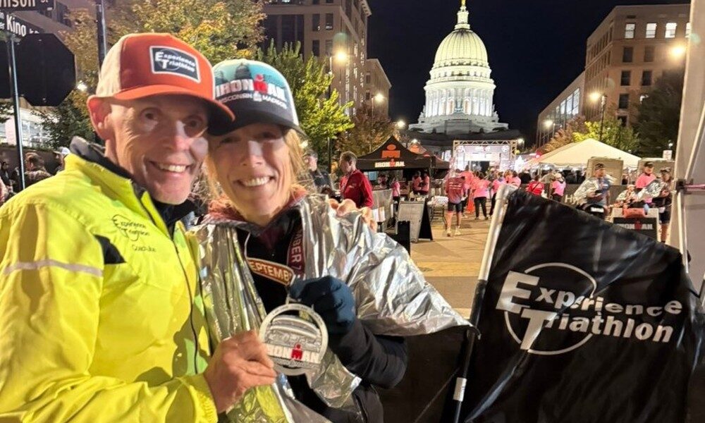 christa and joe imwi 2025 finishline with flag 1000w christa and joe imwi 2025 finishline with flag 1000w